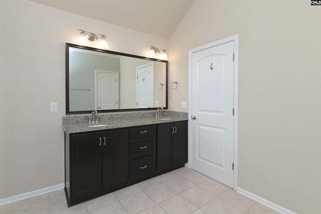 bathroom with tile patterned floors, vanity, and lofted ceiling