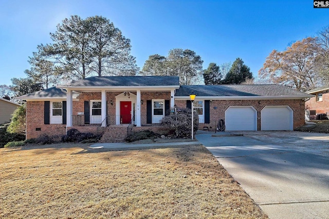 view of front of house with a porch, a garage, and a front yard