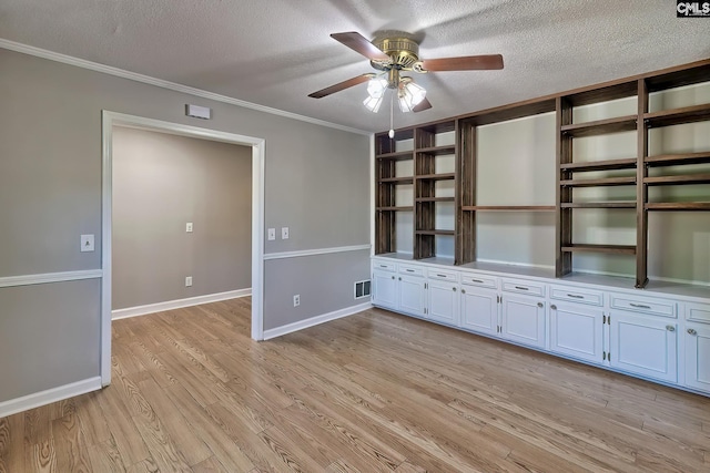 unfurnished living room with ceiling fan, light hardwood / wood-style flooring, a textured ceiling, and ornamental molding