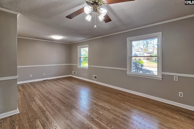 unfurnished room with hardwood / wood-style flooring, crown molding, and a wealth of natural light