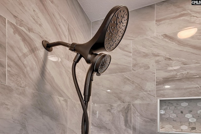 interior details featuring a tile shower