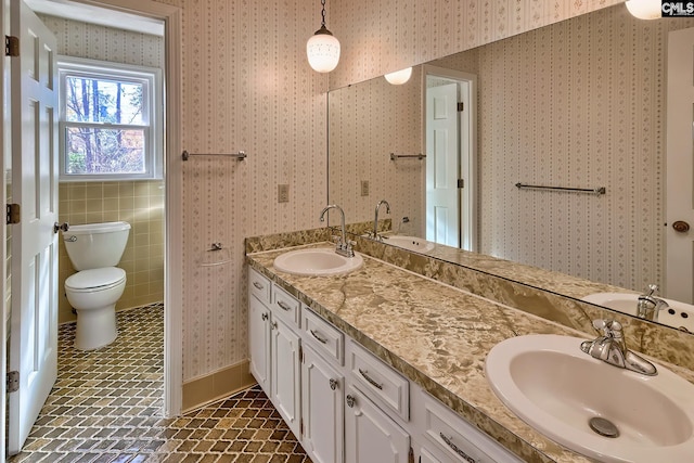 bathroom featuring tile patterned floors, vanity, and toilet