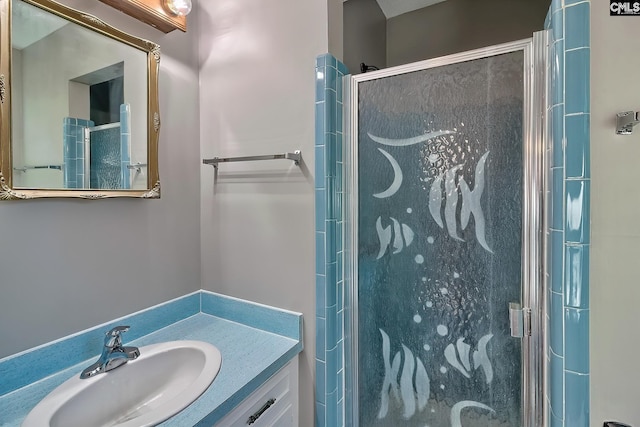 bathroom with vanity and a shower with door