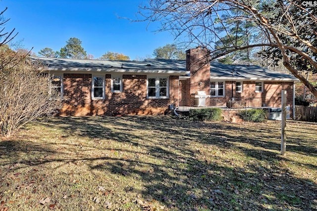 back of house with a lawn