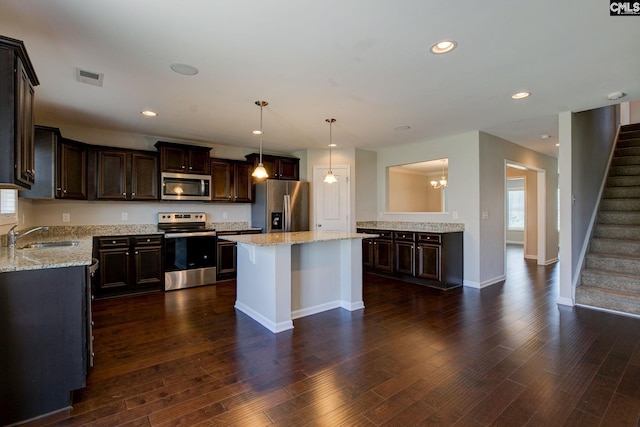 kitchen with pendant lighting, a center island, sink, dark hardwood / wood-style floors, and stainless steel appliances