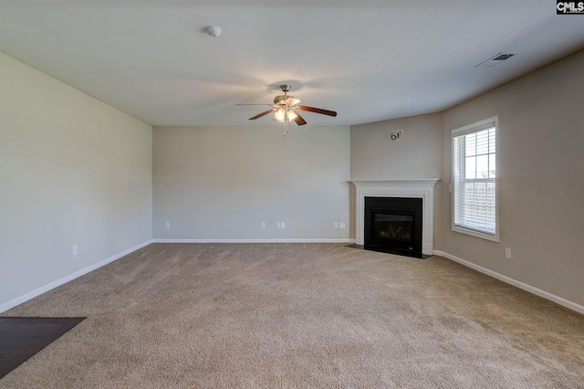 unfurnished living room featuring ceiling fan and light carpet