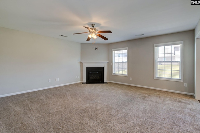 unfurnished living room featuring ceiling fan and light colored carpet