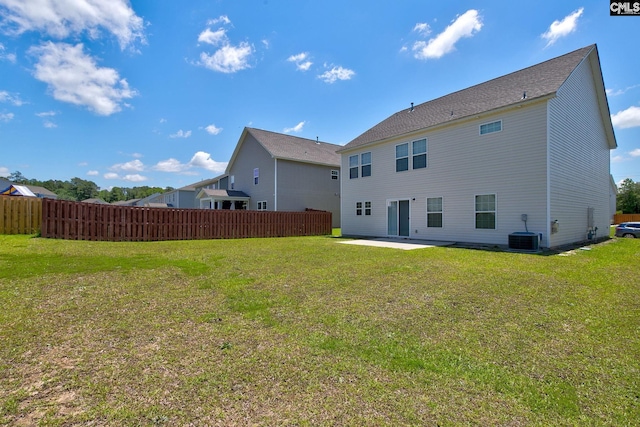 rear view of house featuring a patio, central AC unit, and a lawn