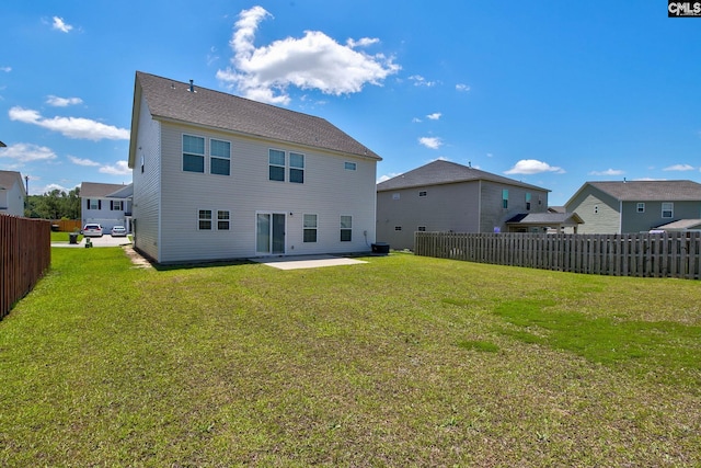 back of house with a lawn and a patio area