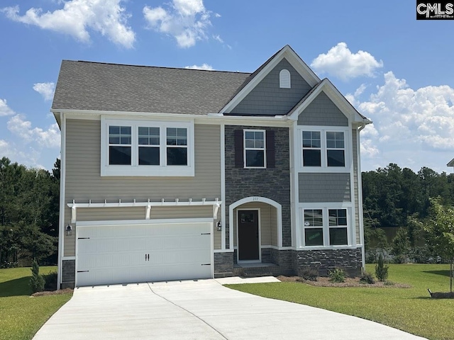 view of front of house with a front yard and a garage