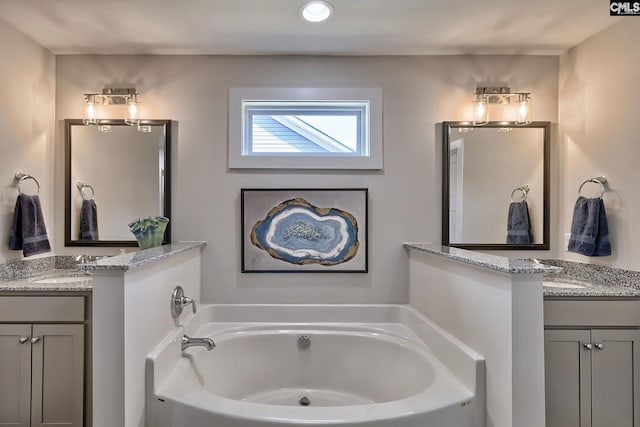 bathroom with vanity and a tub to relax in