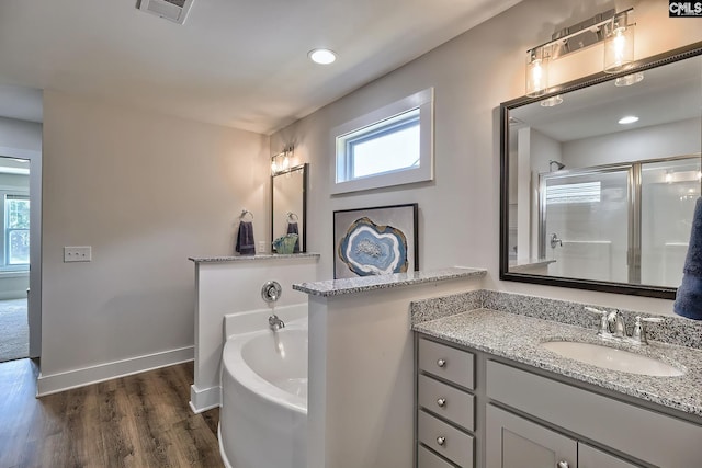 bathroom featuring hardwood / wood-style floors, vanity, and independent shower and bath