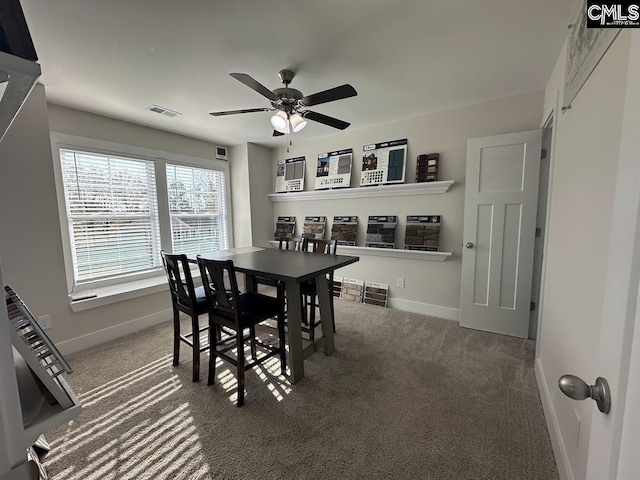 carpeted dining area featuring ceiling fan