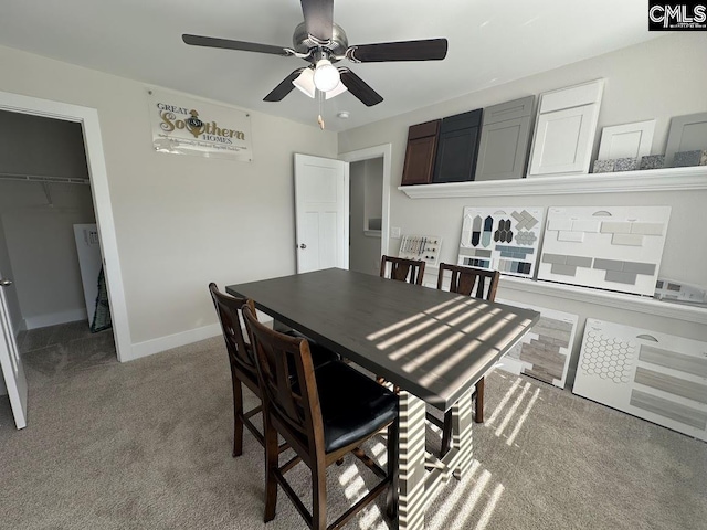 dining space featuring light colored carpet and ceiling fan