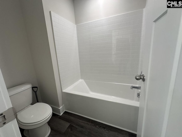 bathroom with hardwood / wood-style floors, toilet, and shower / bathtub combination