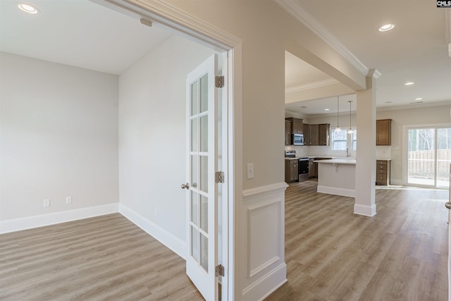 interior space featuring crown molding and light hardwood / wood-style floors