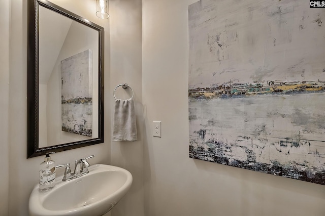 bathroom with sink and vaulted ceiling