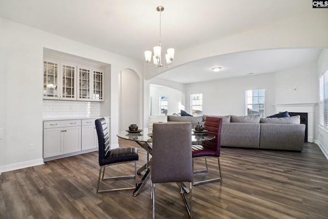 dining space featuring a notable chandelier and dark hardwood / wood-style flooring