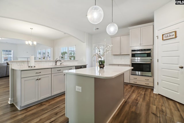 kitchen with pendant lighting, a center island, and a wealth of natural light