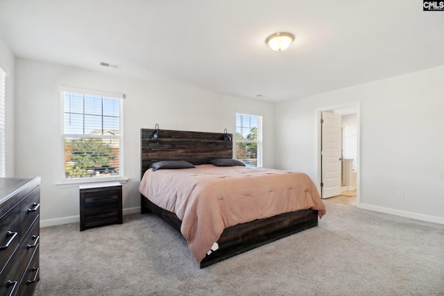 carpeted bedroom with connected bathroom