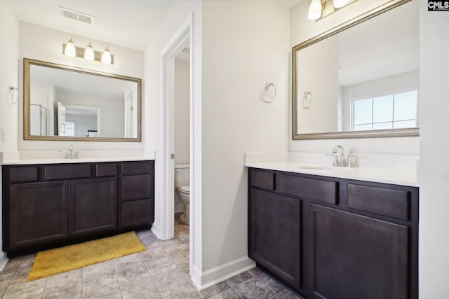 bathroom featuring tile patterned flooring, vanity, and toilet