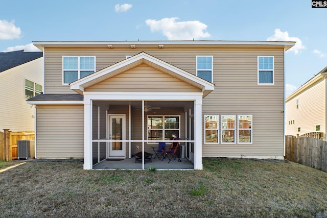 back of house featuring a sunroom, a yard, and a patio