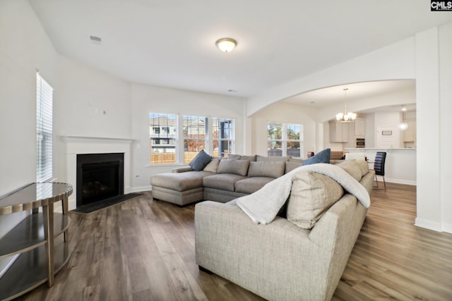 living room featuring hardwood / wood-style flooring and a chandelier