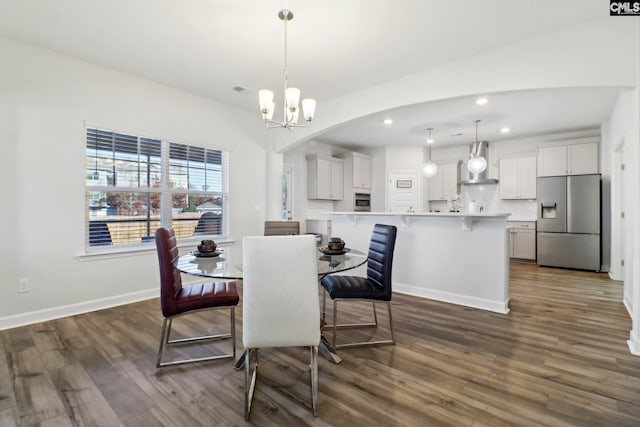 dining room featuring dark wood-type flooring and a notable chandelier