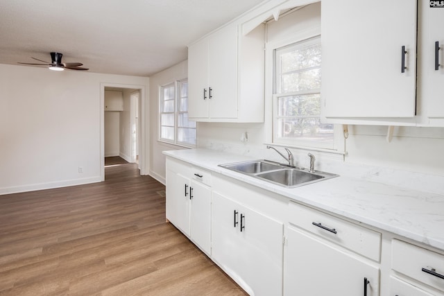 kitchen featuring white cabinets and sink