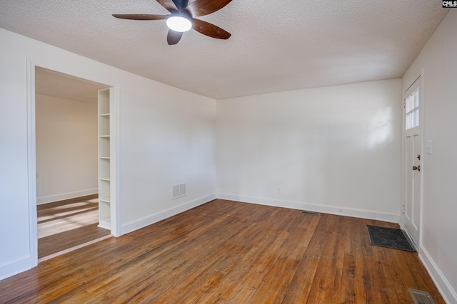 unfurnished room featuring wood-type flooring, a textured ceiling, and ceiling fan