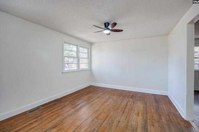 spare room with ceiling fan, a textured ceiling, and hardwood / wood-style flooring