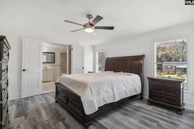 bedroom featuring ceiling fan, hardwood / wood-style floors, and ensuite bathroom