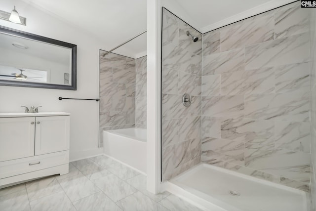 bathroom featuring a tile shower, vanity, and ceiling fan