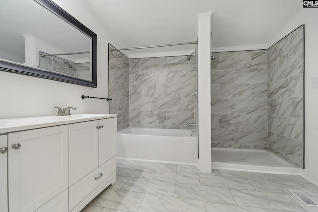 bathroom with vanity and tiled shower / bath