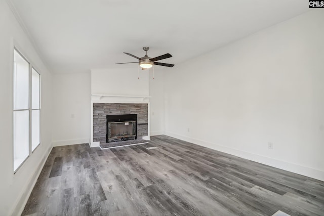 unfurnished living room with a stone fireplace, ceiling fan, and hardwood / wood-style floors