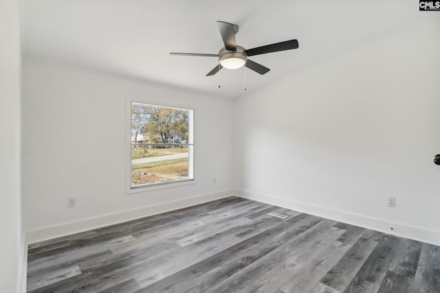 unfurnished room featuring ceiling fan and dark wood-type flooring