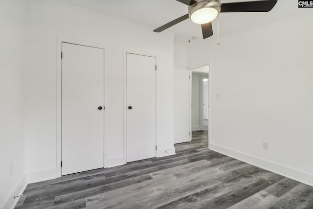 unfurnished bedroom with dark hardwood / wood-style floors and ceiling fan