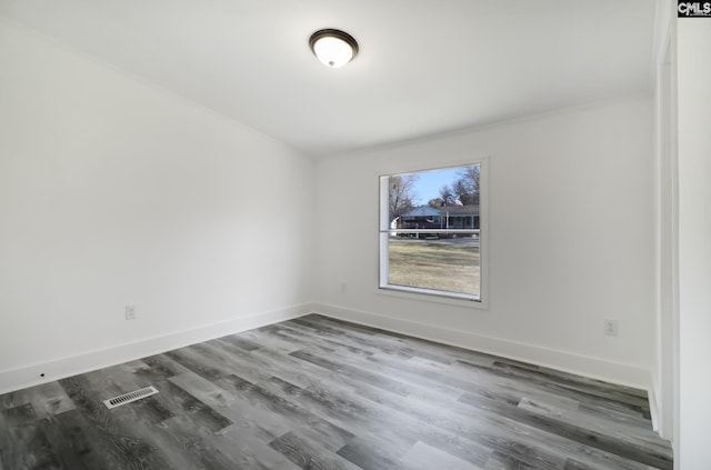 spare room with dark wood-type flooring