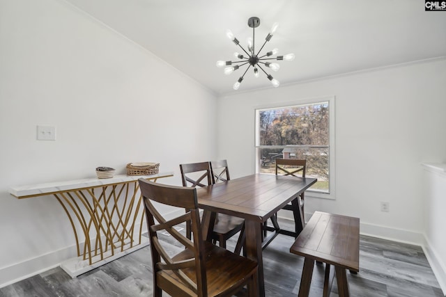 dining space with an inviting chandelier, dark wood-type flooring, and crown molding