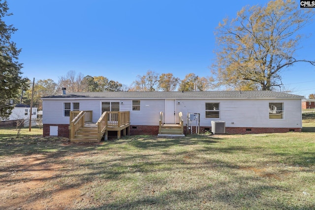 back of house featuring a yard, central AC, and a deck