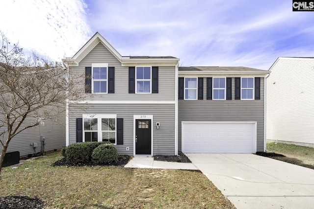 view of front of home featuring a garage and a front yard