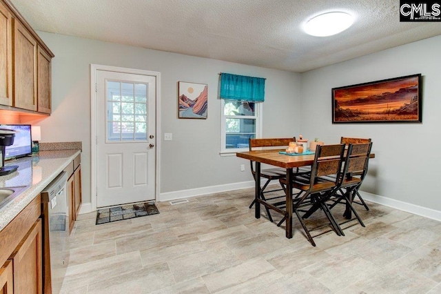 dining room with a healthy amount of sunlight and a textured ceiling