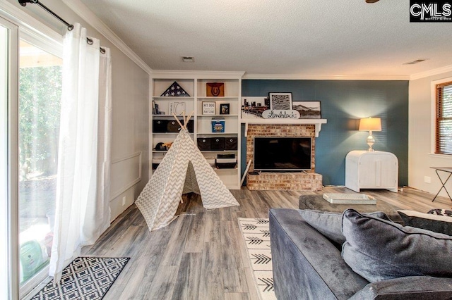 living room with hardwood / wood-style floors, a textured ceiling, and plenty of natural light