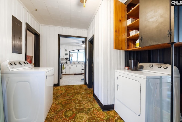 laundry area featuring washer and dryer, ceiling fan, and electric panel