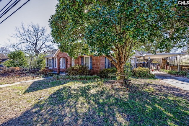 ranch-style home featuring a front yard and a carport