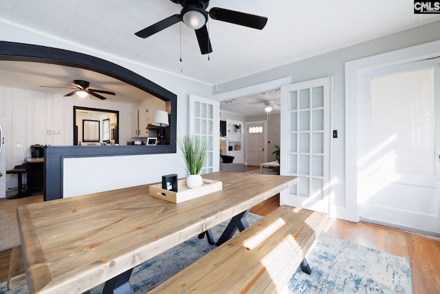 dining room with french doors and light hardwood / wood-style flooring