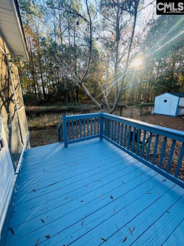 wooden deck featuring a storage shed