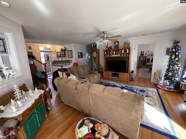 living room with ceiling fan and light wood-type flooring