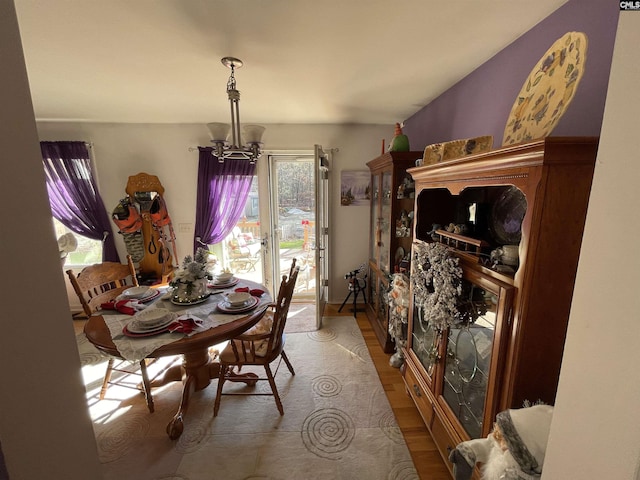 dining space featuring hardwood / wood-style flooring and a notable chandelier