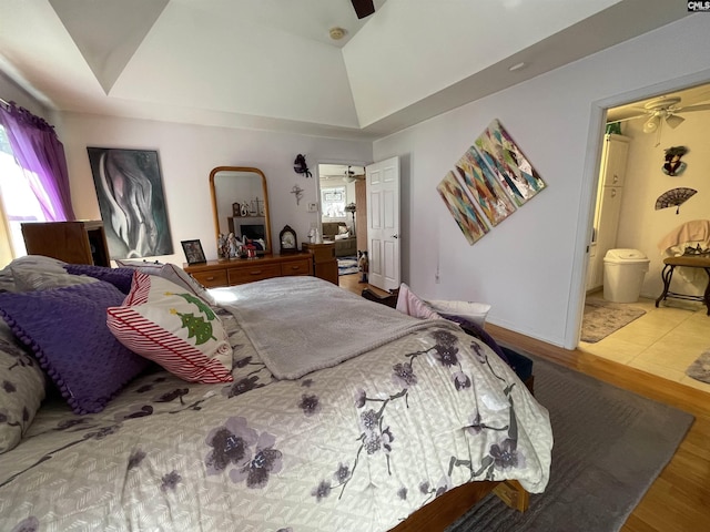 bedroom with hardwood / wood-style flooring and ensuite bathroom